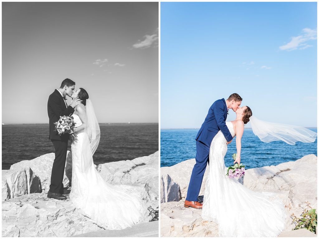 Groom leaning over bride for a kiss while her veil blows in the wind on Lake Michigan in Milwaukee