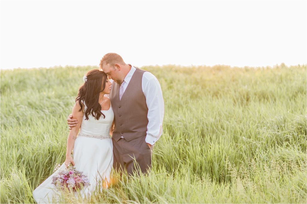 Bride and groom snuggle during sunset at their Waukesha wedding