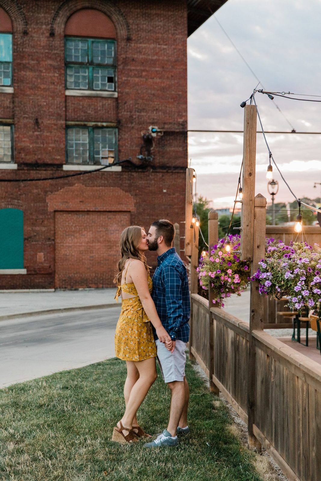 Milwaukee Engagement Session | Engaged couple kissing at brewery patio